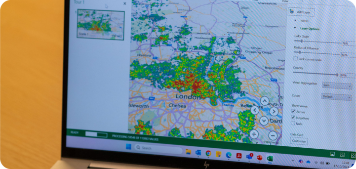A laptop shows a heatmap of London