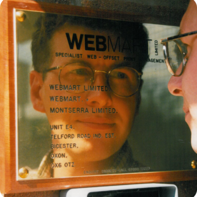 Webmart etched into metal sign, reflecting founder image.