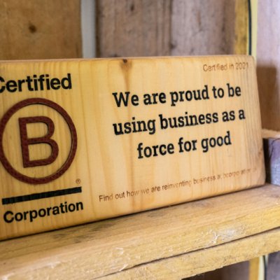 Wooden Certified B Corp sign. Certified in 2021. Webmart marketing agency.