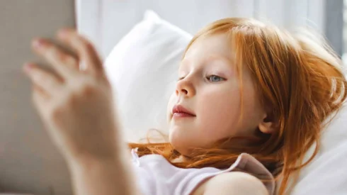 A child lies down reading a book - photo for Webmart case study. Pain-free print management for book publisher.