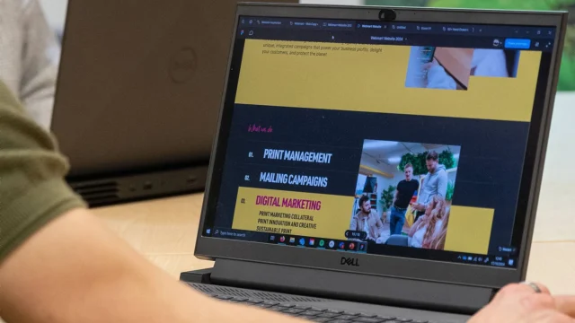 A laptop shows the Webmart website and digital marketing services page