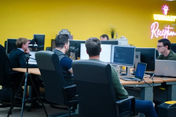 A team of marketing specialists work at desks at Webmart's head office in Bicester