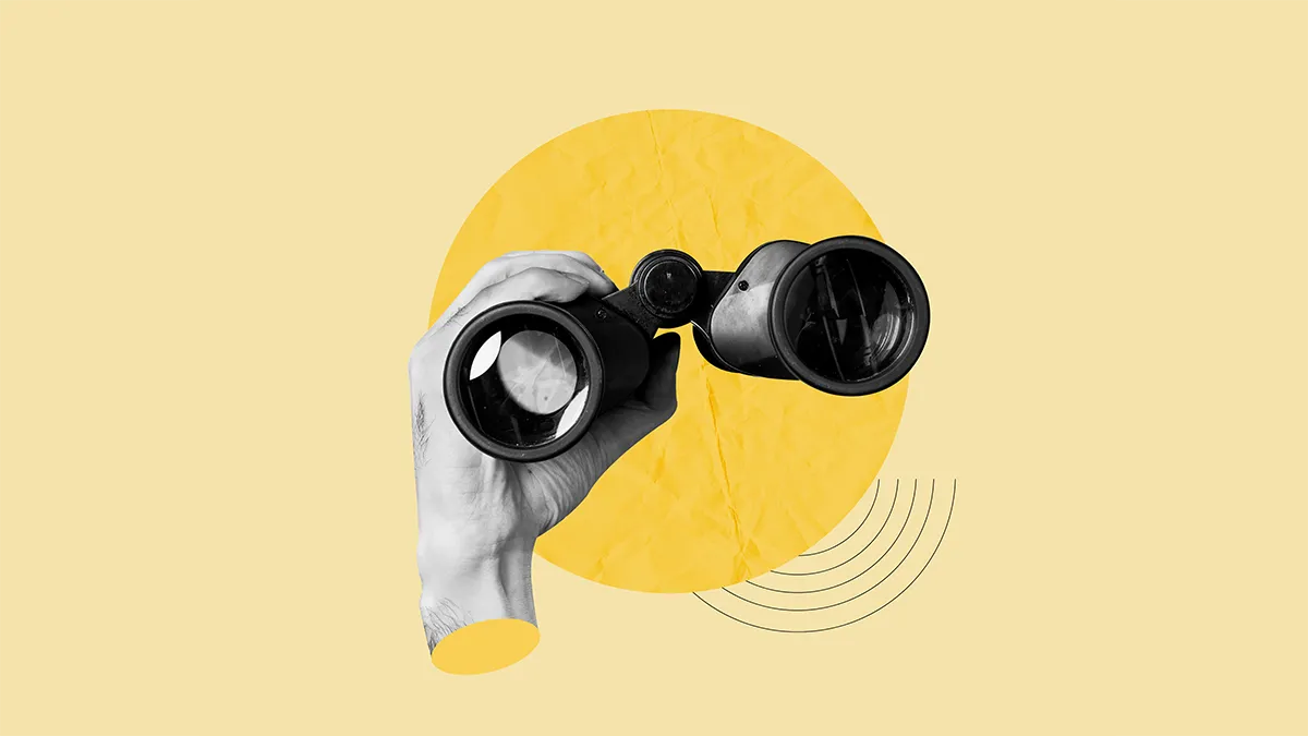 a hand holds binoculars to represent searching for a good print specialist