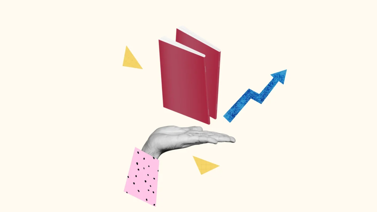 a hand is held flat holding books that have been saddle stitched