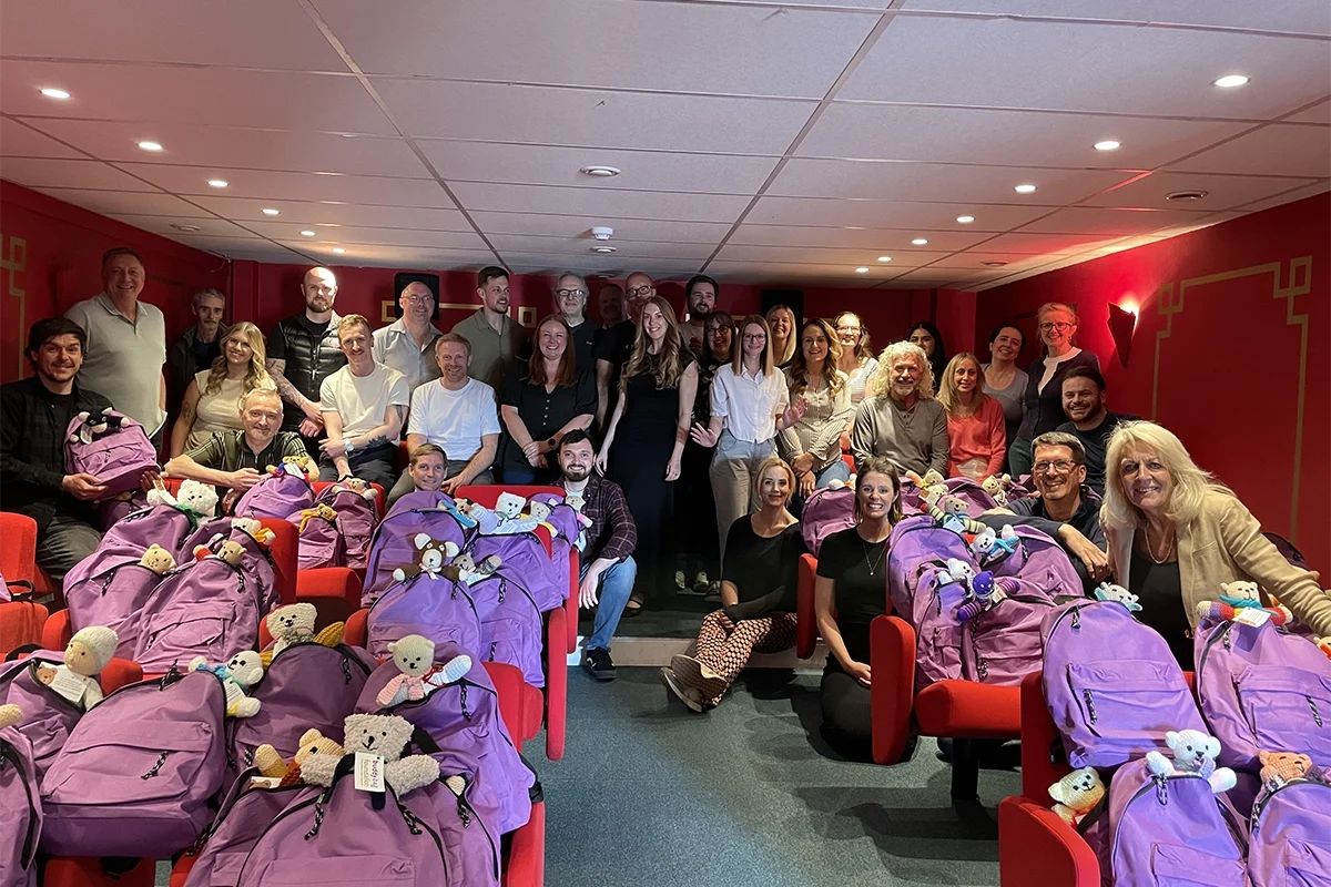 The Webmart Team in our cinema room with our 144 Buddy Bags packed during our charity day