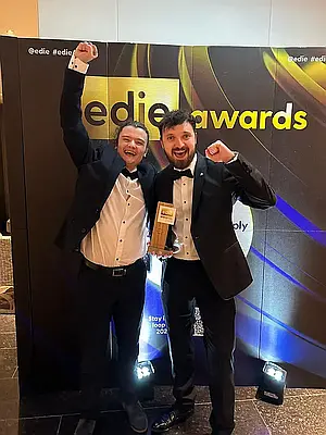 Webmart's ashton and tom celebrating winning the Edie Award